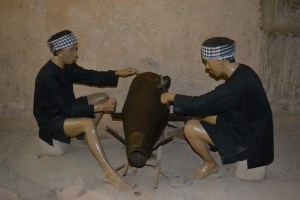 Vietnamese "soldiers" cutting unexploded bombs to extract the explosives....